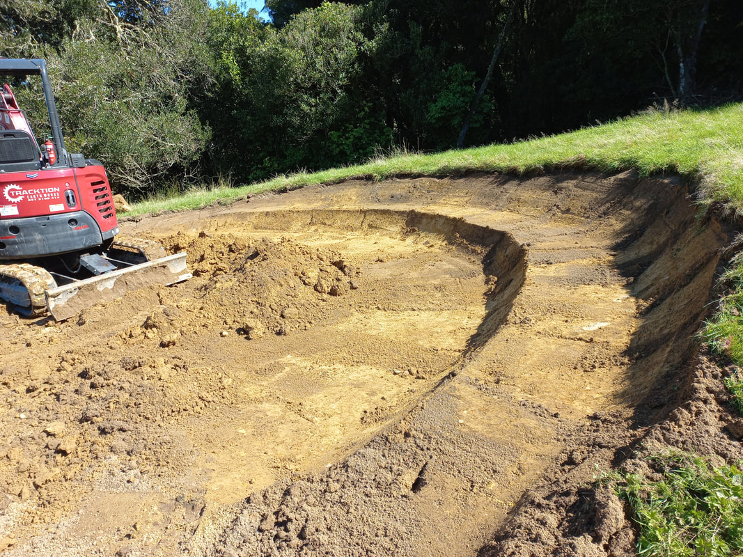 Earthworks shaping a sloped section